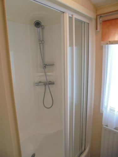 a shower in a bathroom with a shower at 8 Berth Central heated Golden Palm (Aspen GP) in Chapel Saint Leonards