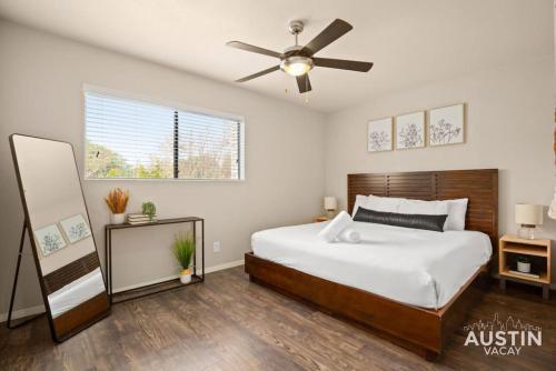 a bedroom with a bed and a ceiling fan at Minutes to Zilker, Barton Springs and Free Parking in Austin