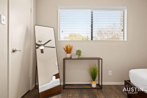 a bedroom with a mirror and a table with plants at Minutes to Zilker, Barton Springs and Free Parking in Austin
