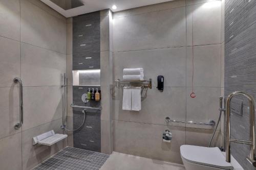 a bathroom with a shower and a toilet at Holiday Inn & Suites - Al Khobar by IHG in Al Khobar