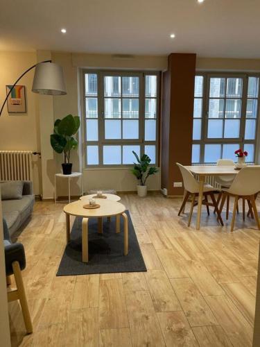 a living room with a table and a dining room at T5 COEUR DE VILLE in Besançon