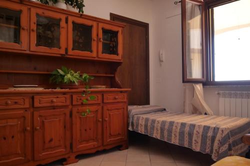 een slaapkamer met een grote houten kast en een bed bij Casa vacanza Riparbella in Riparbella