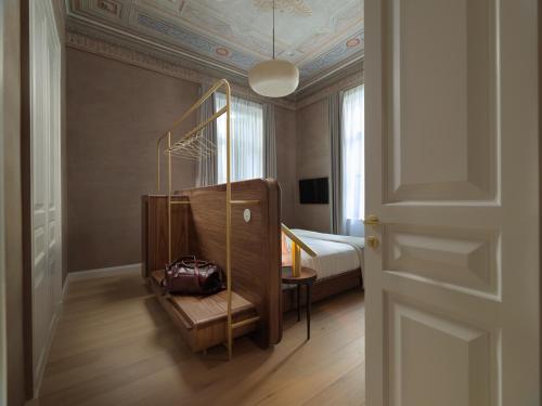 a bedroom with a bed and a chair in a room at Monument Hotel in Athens