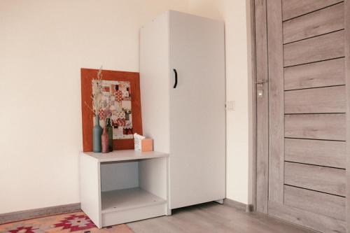 a room with a white cabinet next to a door at Taniq Guesthouse in Artsvaberd
