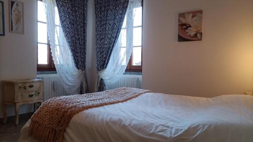 Lakeside apartment Tremezzo - Larihome B01 في تريميزو: غرفة نوم بسرير ونوافذ