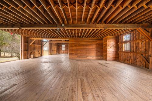 a large room with a wooden floor in a barn at Stratton Creek Inn in Stratton