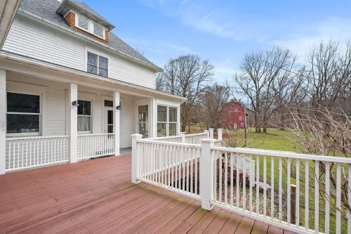 a house with a white fence on a wooden deck at Stratton Creek Inn in Stratton