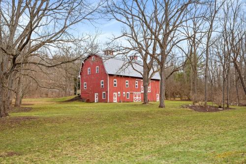 a large red barn in a field with trees at Stratton Creek Inn in Stratton