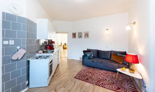 een woonkamer met een bank en een keuken bij Silvie Apartments - Šmeralova in Olomouc
