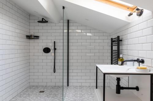 a bathroom with a shower and a sink at Stunning refurbished Chateau in South West France in Ornézan