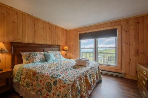a bedroom with a bed and a large window at Mountain Stay Chalet in Beech Mountain