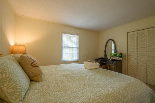 a bedroom with a bed and a mirror and a window at Mountain Stay Chalet in Beech Mountain