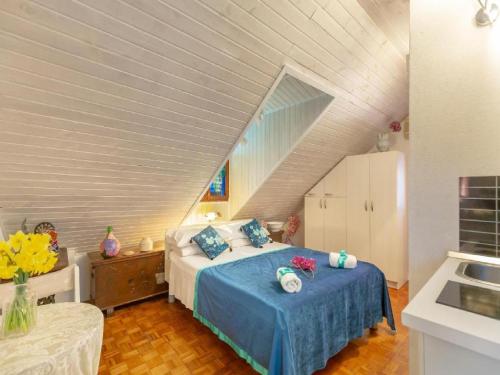 a bedroom with a bed with blue sheets in a attic at Tulip Old Town in Dubrovnik