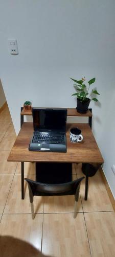 a laptop computer sitting on a wooden table at Warmisitay HOME in Lima