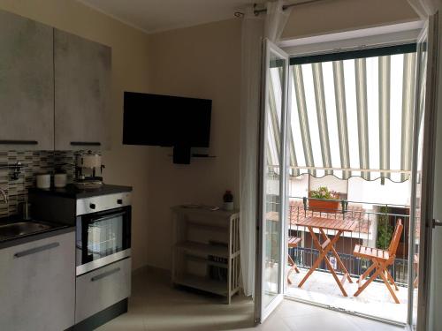 a kitchen with a sliding glass door leading to a patio at casa bea in Aci Castello