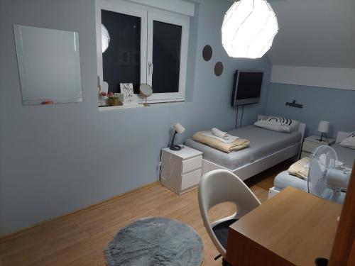 a living room with a bed and a table at Ivančica in Aljmaš
