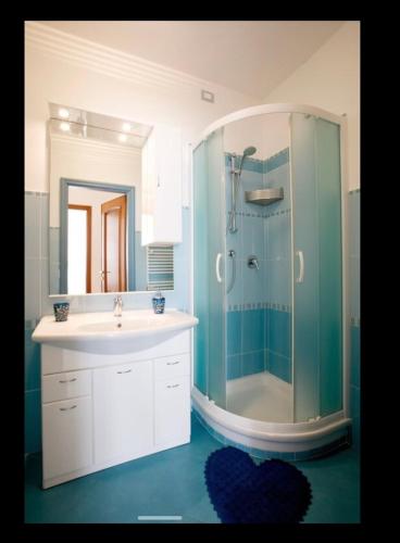 a bathroom with a sink and a glass shower at Casa Gelsomino in Levanto