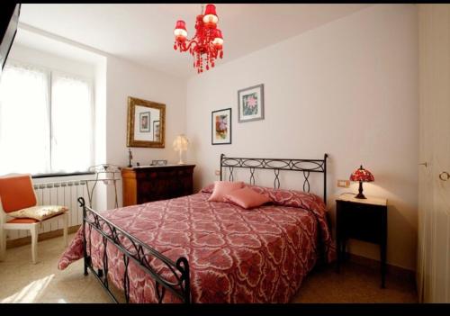 a bedroom with a bed and a chandelier at Casa Gelsomino in Levanto