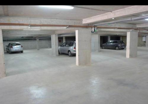 a parking garage with several cars parked in it at Sky Penthouse Old Bridge with sauna and jacuzzi in Mostar