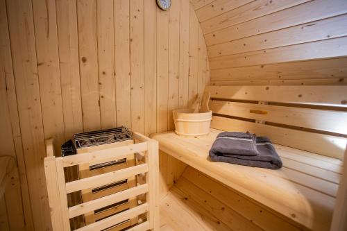 a wooden sauna with a stove on a counter at Sky Penthouse Old Bridge with sauna and jacuzzi in Mostar