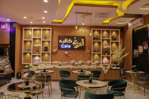 a restaurant with tables and chairs and a sign that reads cafe at Arkan Al Barzah Hotel Apartment in Sur