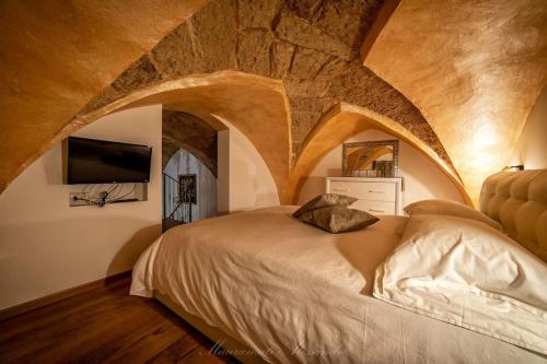 a bedroom with a large bed in a stone room at La Corte GIO' in Taurisano