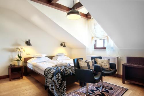 a bedroom with a bed and a table and chairs at BoutiqueHotel Aristo in Białystok