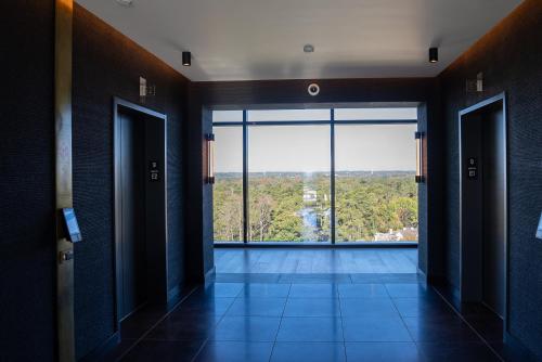 a hallway with doors open to a large window at Nobu Hotel Atlanta in Atlanta