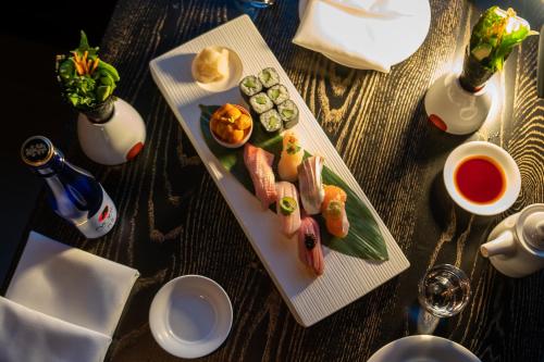 a table with two plates of sushi and a drink at Nobu Hotel Atlanta in Atlanta