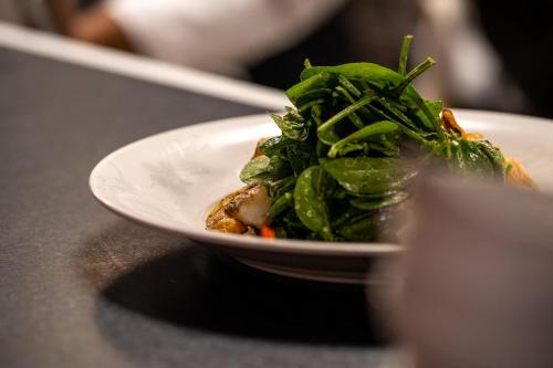 a white plate with a salad on a table at Nobu Hotel Atlanta in Atlanta