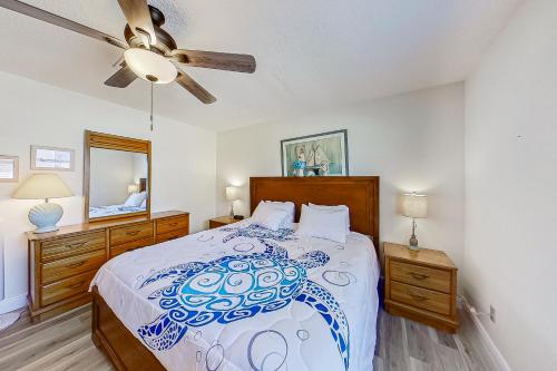 a bedroom with a bed and a ceiling fan at The Englewood Twin Palms in Englewood