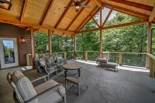 a screened in porch with chairs and a table at Heavenly Manor in Boone