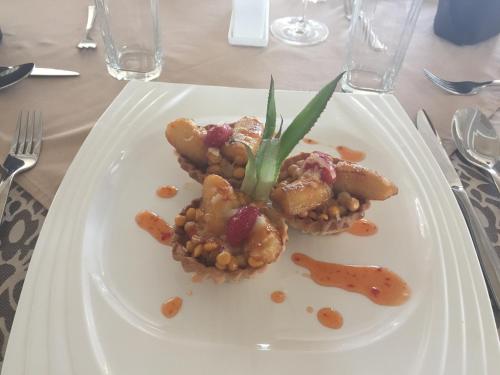 a white plate with food on a table at Addissinia Hotel in Addis Ababa