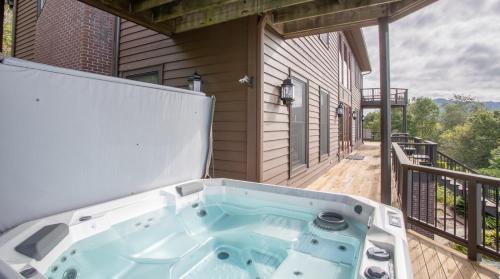 a hot tub on the back porch of a house at The Retreat at Mountain Meadows in Banner Elk