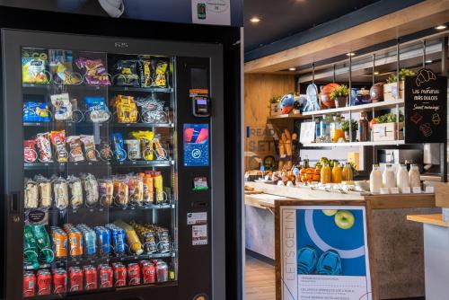 a soda vending machine in a store with drinks at Ibis Budget Madrid Calle Alcalá in Madrid