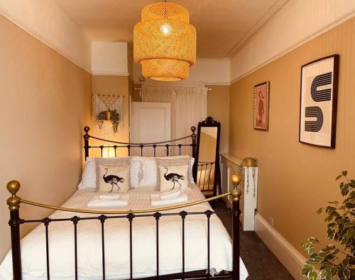 a bedroom with a bed with two cats on the pillows at Stunning seafront apartment in Brighton & Hove