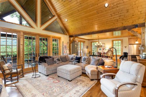 a living room with a couch and chairs andwindows at The Ponderosa in Boone