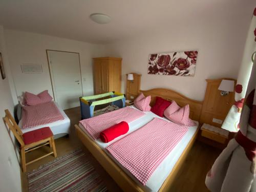 a small bedroom with two beds and a mirror at Familienbauernhof Strassbauer in Steinakirchen am Forst