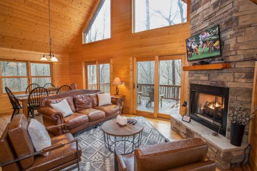 a living room with a couch and a fireplace at New River Lure in West Jefferson