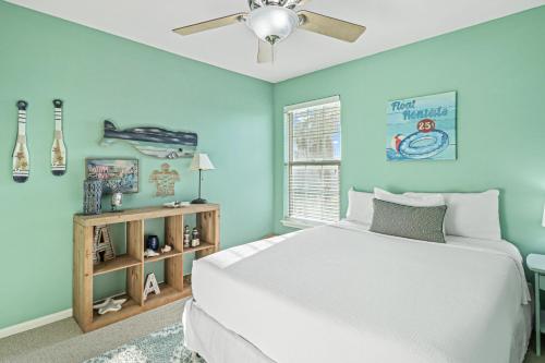 a bedroom with a white bed and a ceiling fan at Water View Wonder in Padre Island