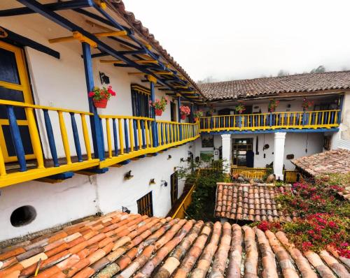 an aerial view of a building with yellow and blue balconies at Hotel Museo la Posada del Molino in El Cocuy