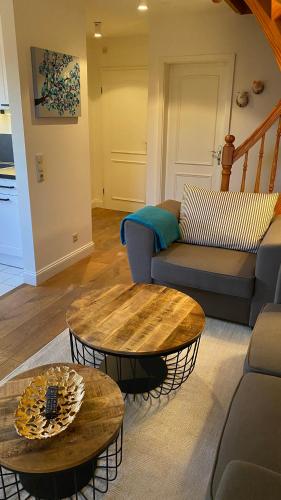 a living room with a couch and a table at Hotel Kiose in Wenningstedt
