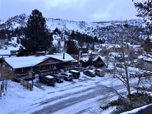 a house with cars parked in the snow at Heidelberg Inn & Resort in June Lake