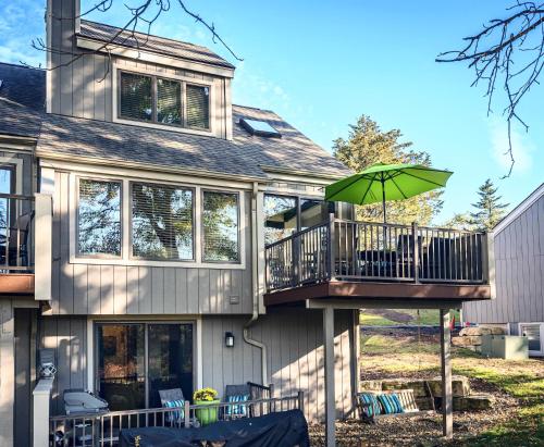 a house with a balcony with an umbrella at Three Kings and A Little Bling in Galena