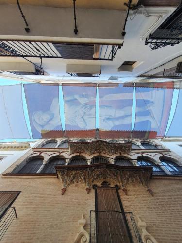 a large mural on the side of a building at LA CASA MIRADOR DE ÉCIJA in Écija