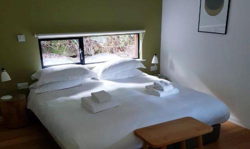 a large white bed in a room with a window at Yorkshire Dales Lodge 8 by Together Travel - 3-Bed Ensuite Retreat in Richmond