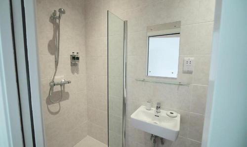 a bathroom with a shower and a sink and a shower at Yorkshire Dales Lodge 8 by Together Travel - 3-Bed Ensuite Retreat in Richmond