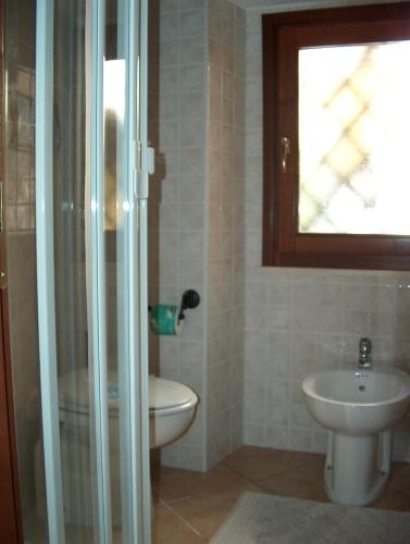 a bathroom with a toilet and a sink at Guest House Il Giardino Segreto in Cagliari