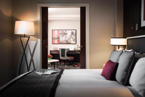 a bedroom with a bed and a desk in a room at Sofitel Lafayette Square Washington DC in Washington
