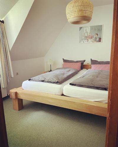 a bedroom with a bed with a wooden frame at Hotel Gut Schöneworth in Freiburg - Elbe